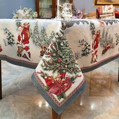 a christmas themed table cloth with santa claus on it