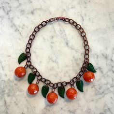 This Exceedingly Unique Vintage Costume Jewelry Piece Is Made Entirely Of Bakelite, It's Fruit And Leaf Ornaments Hanging From A Chain Of Semi-Opaque Brown Bakelite Chain Links. This Piece Fits Close To The Neck. From The Personal Jewelry Collection Of Holly Solomon, Esteemed New York Art Dealer. Internal Diameter 4 ⅞", External Diameter 6 ¼", Depth ¾" Double Horn Necklace, Beaded Boho Necklace, Leaf Ornament, Agate Pendant Necklace, Crystal Choker Necklace, Horn Necklace, Orange Leaf, Vintage Bakelite, New York Art