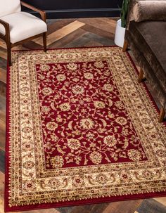 a red area rug with gold border and floral design on the bottom in a living room