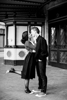 a man and woman kissing on the street