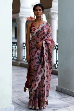 Rosewood pink saree with intricate hand painted kalamkari floral patterns, signature thread and mirror work border. Paired with silk embroidered bralette blouse.
Component: 2
Pattern: Hand Painted, Embroidered
Type Of Work: Kalamkari, Floral Patterns
Neckline: V-Neck
Sleeve Type: Sleeveless
Fabric: Silk
Color: Pink
Other Details: 
Embroidered scalloped hem saree
Embroidered blouse
Length: Saree- 5.50 Mtrs
Occasion: Wedding, Bride
Disclaimer: This product will be exclusively handcrafted, making t Archana Jaju Sarees, Archana Jaju, Mirror Work Border, Long Blouse Designs, Kalamkari Designs, Fashionable Saree Blouse Designs, Draping Fashion, Sari Blouse Designs, Kalamkari Saree