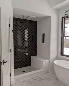 a white bath tub sitting next to a walk in shower