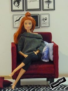 a doll is sitting on a red chair