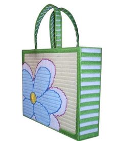 a handbag with a flower on the front and green stripes in the bottom half