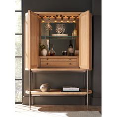 a wooden cabinet with wine glasses on it