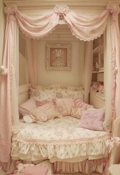 a canopy bed with pink and white decor in a girls's room or bedroom