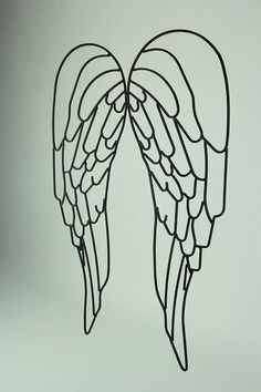 two metal angel wings on a white background