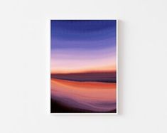 an abstract painting with blue, purple and orange colors on the wall above it is a white square frame