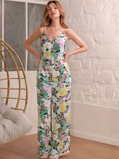 This Floral Print Cami Jumpsuit Without Belt is perfect for making a bold style statement. Its beautiful multicolor floral print captures the essence of boho fashion while its sleeveless design and spaghetti straps make it perfectly suited for summer days. Crafted from non-stretch woven fabric, this jumpsuit has a high waistline with a regular fit that flatters your figure. The backless detail adds an extra touch of charm and it’s fully lined with polyester fabric to keep you comfortable all day long. With its versatile style, this cami jumpsuit looks great on any occasion! Features: Color: Multicolor Style: Boho Pattern Type: Floral, All Over Print Details: Backless Length: Long Type: Cami Fit Type: Regular Fit Neckline: Spaghetti Strap Sleeve Length: Sleeveless Waist Line: High Waist Fab Multicolor Tropical Print V-neck Jumpsuits And Rompers, Green Floral Print Jumpsuit For Brunch, Green Floral Print Jumpsuits And Rompers For Brunch, Beach Printed Patterned Jumpsuits And Rompers, Chic Cami Jumpsuits And Rompers For Spring, Green Tropical Print Jumpsuits And Rompers For Spring, Chic Cami Jumpsuits For Summer, Chic Summer Cami Jumpsuits And Rompers, Spring Floral Print Jumpsuits With Spaghetti Straps