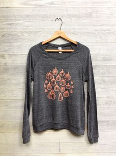 "my signature lightweight pullover is printed with my hand drawing Pumpkin Patch Design in orange ink. Pullover is lightweight and perfect for the transition from summer to fall. super comfy, lightweight and perfect for all the halloween and autumn loving ladies. Colors: Charcoal small: chest- 38\", length- 23\" medium: chest- 40\", length- 24\" large: chest- 44, length- 26\" xlarge: chest- 46\", length- 27\"" Pumpkin Patch Design, Halloween Top, My Signature, Summer To Fall, Pumpkin Shirt, Foodie Gifts, Cool Halloween Costumes, Halloween Fashion, Mom Dress