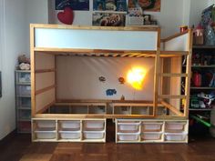 a bunk bed with lots of storage underneath it in a child's playroom