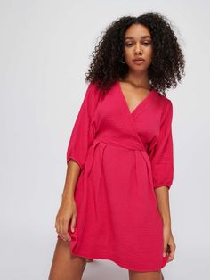 With a wrap front, three-quarter balloon sleeves, gathered waist with pintuck front, and an effortlessly feminine silhouette, this is the dress that's made for romance. Pairs well with date night, and brunch the morning after. IYKYK. (This one comes in Hibiscus.) | Hedy Dress in Hibiscus | Ethical Essentials Feminine Flowy Wrap Dress With Surplice Neckline, Feminine Daywear Dress With Surplice Neckline, Spring Dress With Gathered Sleeves And Surplice Neckline, Feminine Wrap Dress With Surplice Neckline For Date Night, Feminine Midi Dress With Surplice Neckline For Daywear, Pink Wrap Dress With Surplice Neckline For Brunch, Feminine Wrap Dress With Surplice Neckline For Brunch, Pink Surplice Neckline Wrap Dress For Brunch, Feminine Surplice Neckline Wrap Dress For Brunch