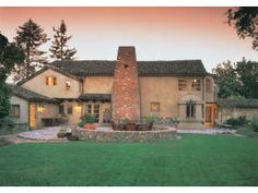 a large house with a fire place in the front yard