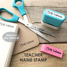 two personalized teacher name stamps, one with a pair of scissors and the other with a rubber stamp