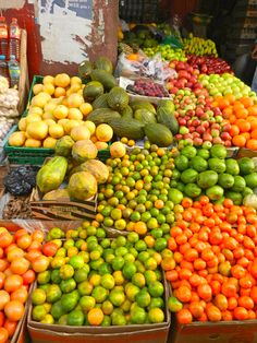 many different types of fruits and vegetables on display