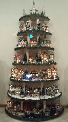 a christmas tree made out of many different types of ornaments and trees with lights on them