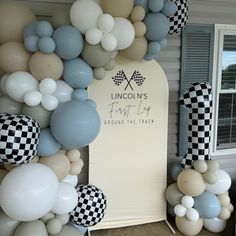 balloons and checkered flags decorate the entrance to a party at lincoln's first up