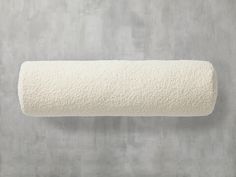 a white toilet roll on a gray wall