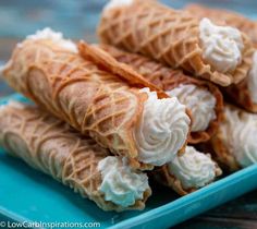 three waffles filled with whipped cream on a blue plate