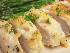 chicken breast and asparagus on a plate with parsley garnishes