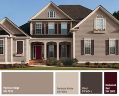 a house with brown siding and red doors