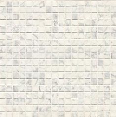 a white and grey tile wall with small squares