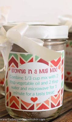 a jar filled with brownie in a mug mix on top of a wooden table