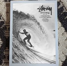 a man riding a wave on top of a surfboard