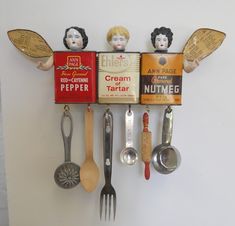 an assortment of kitchen utensils hanging on a wall