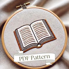 an embroidered book with the words pdf pattern on it