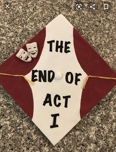 a red and white graduation cap that says the end of act i