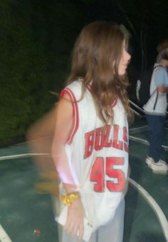 a woman standing on top of a basketball court