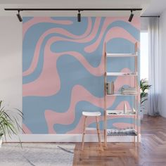 a living room with a pink and blue wall mural