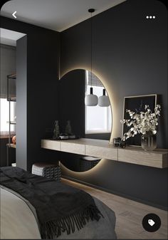 a modern bedroom with black walls and white bedding, large round mirror on the wall