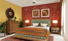 a bedroom with red and yellow wallpaper, white bedding, and wooden furniture