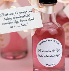 a bottle with some pink liquid in it and a label on the top that says, thank you for coming one helping us celebrate this wonderful day