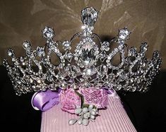 a tiara is sitting on top of a pink box