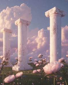 three white pillars in the middle of a field with pink flowers and clouds behind them