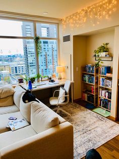 a living room filled with furniture and a book shelf next to a large window covered in books