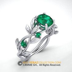 a ring with leaves and green stones on the front, in white gold plated