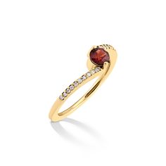 a yellow gold ring with a red stone and diamonds