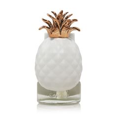 a white and gold pineapple candle holder