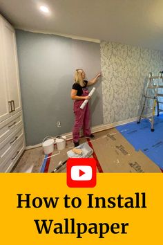 The words "How to Install Wallpaper" sit below a photo of a woman pointing to blue feature wall wallpaper in a bedroom surrounded by a ladder, wallpaper paste and tools. Wallpaper Tips And Tricks, Installing Wallpaper, How To Apply Wallpaper, Hang Wallpaper, Wallpaper Video