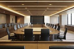 an empty conference room with chairs and a projector screen