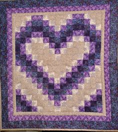 a purple and white quilt with squares on it