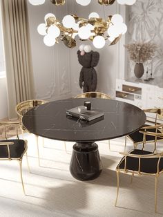 an elegant dining room with gold chairs and a black table surrounded by white rugs