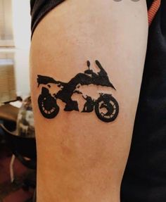 a person with a tattoo on their arm that has a dirt bike drawn on it