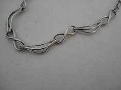 "A highly collectible vintage silver tone panel bracelet by Corocraft. It measures approx 15\" length x 0.25\" width and has a secure ring clasp. Clearly marked hang tag \"Corocraft\" in capital letters preceded by the Pegasus. It is in excellent vintage condition. Postage in the UK is by Royal Mail First Class Signed For service. Postage to all other countries is by Royal Mail Airmail Tracked and Signed For Small Packets service." Retro Silver Metal Bracelets, Silver Retro Metal Bracelets, Retro Silver Bracelet Jewelry, Handmade Retro Silver Jewelry, Retro Silver Bracelet, Retro Silver Metal Jewelry, Vintage Sterling Silver Oval Link Bracelet, Retro Silver Collectible Jewelry, Formal Hallmarked Metal Chain Bracelet