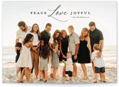 a group of people standing on top of a beach next to the ocean with words peace love joyful