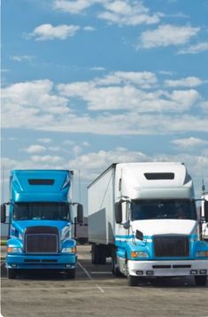 three semi trucks parked in a parking lot under a blue sky with fluffy white clouds